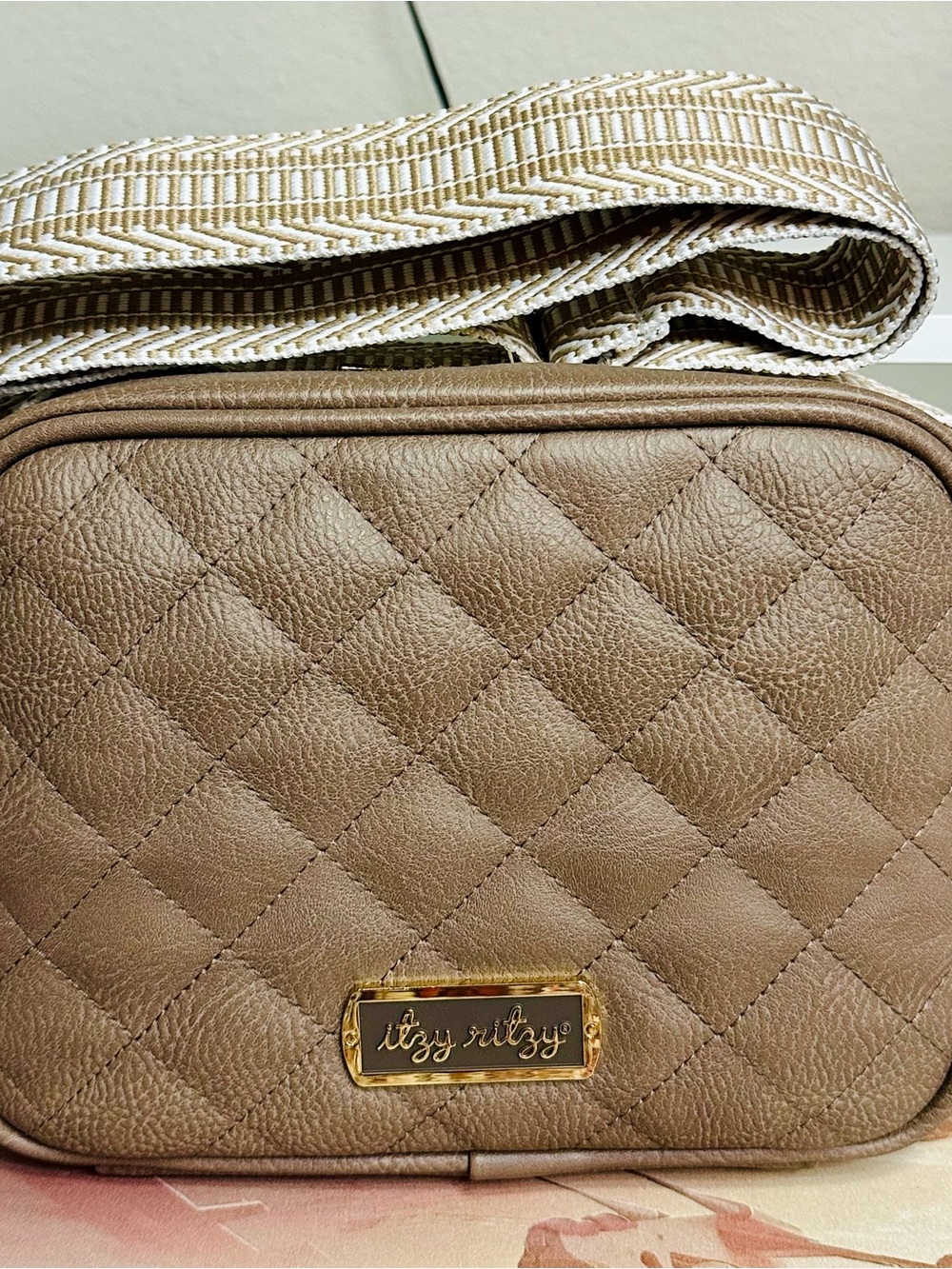 Itzy Ritzy Quilted Crossbody Bag in Taupe with Woven Strap